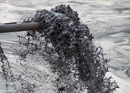 Photo of wastewater entering a coal ash pond