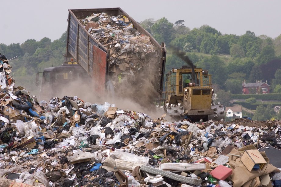 Trash being dumped into a landfill
