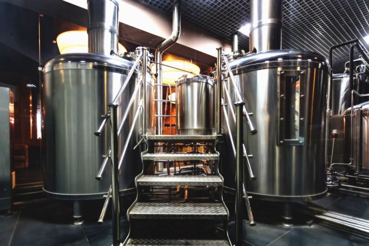 Photo of steel kettles in a brewery