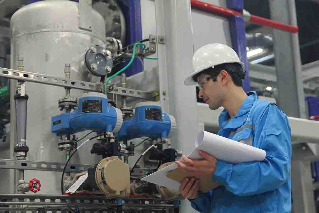 Photo of a Saltworks staff member checking a meter on a SaltMaker MVR crystallizer