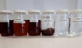 Samples of water going from dark brown to clear